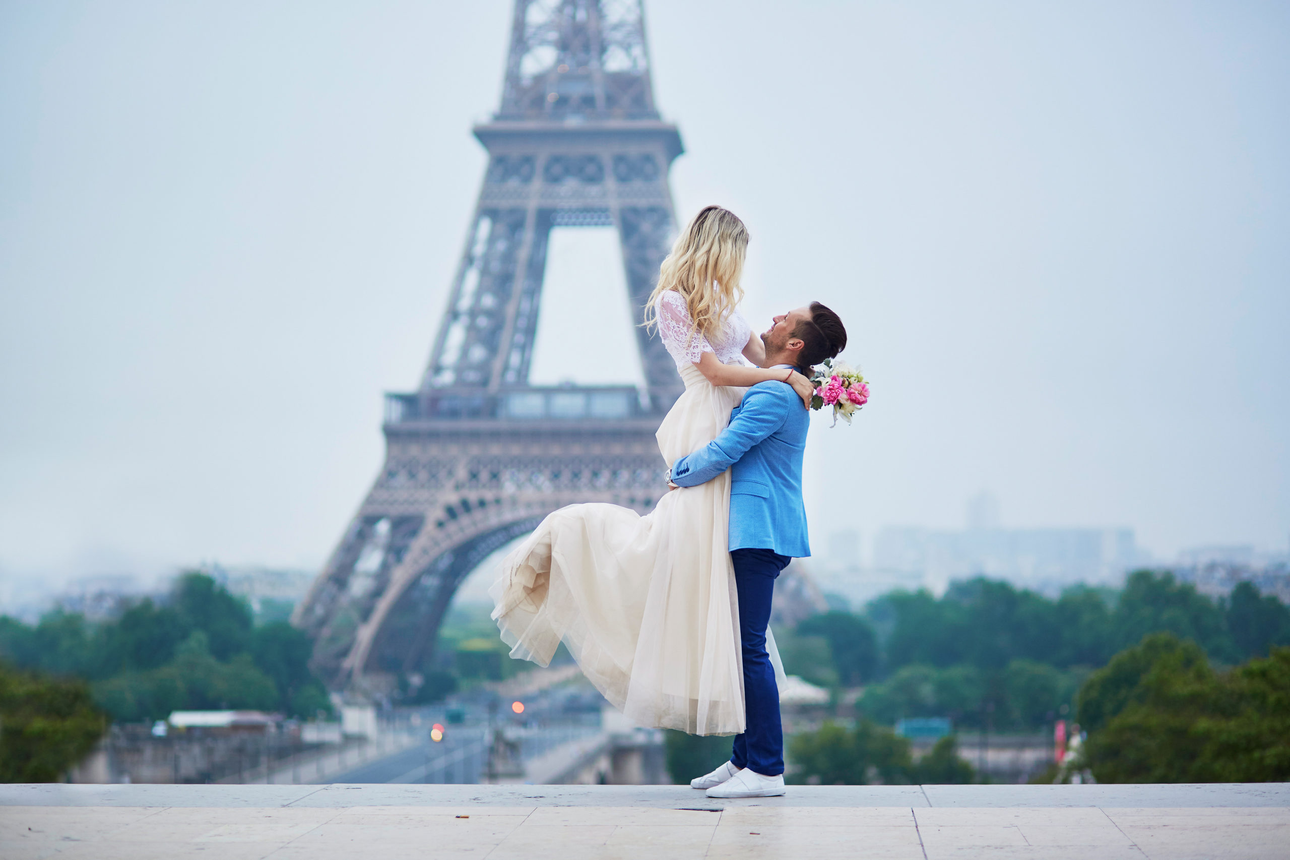 Just married couple in Paris, France. Beautiful young bride and groom near the Eiffel tower. Romantic wedding in Paris concept